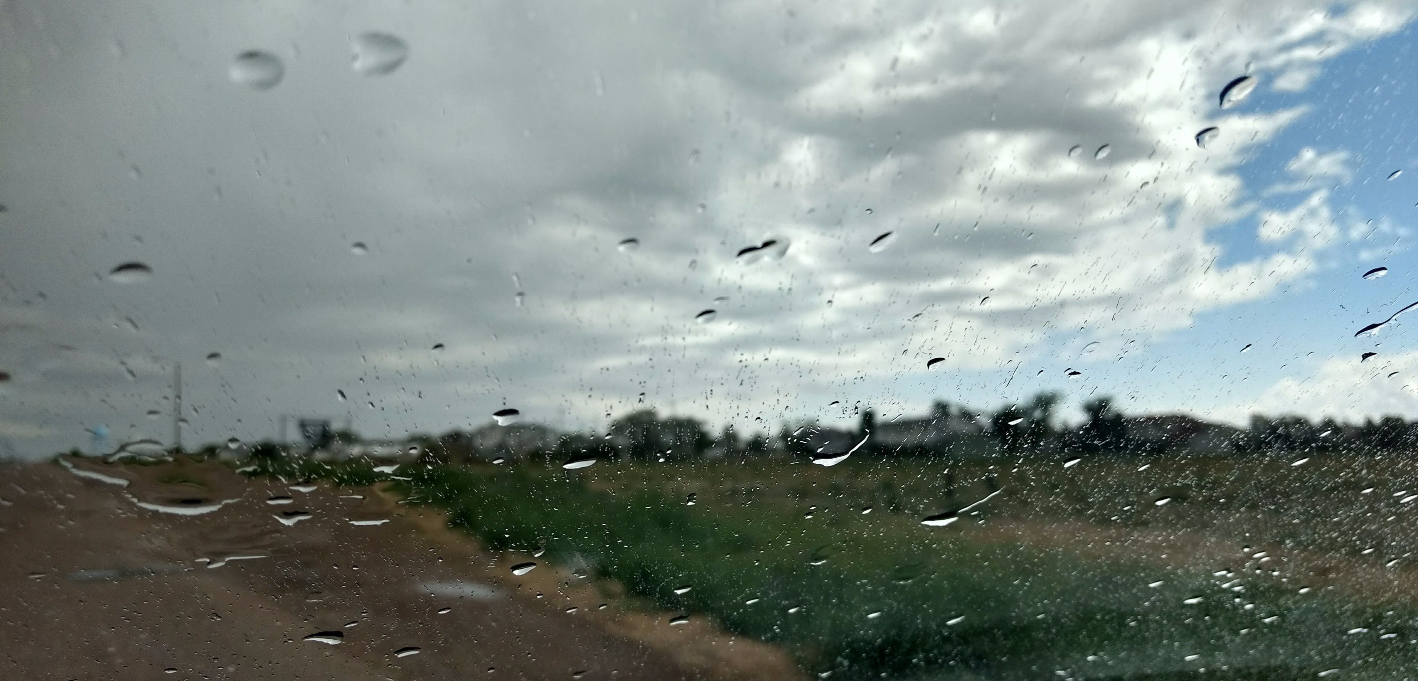 raindrops on a windscreen, a city's horizon visible in background